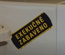 a black and yellow sticker that says " execucne zabaveno "