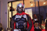 a man in a thor costume stands in front of a sign that says saidddd
