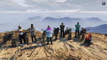 a group of people standing on top of a mountain with their bikes