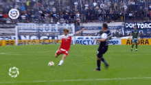 a soccer game is being played in front of a banner that says don toro