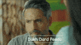 a man with a beard and the words dukh dard peeda on the bottom