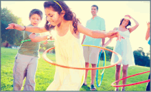 a group of children are playing with hula hoops