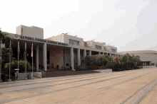 a national forensic sciences university building with flags flying in front of it