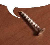 a close up of a screw on a brown surface