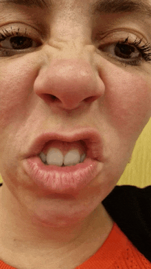 a close up of a woman making a funny face with her mouth open