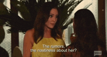 a woman in a yellow dress is talking to another woman with the words the rumors , the nastiness about her .