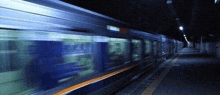 a blurry picture of a subway train going down a train station .