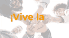 a group of people putting their hands together with the word vive la in orange letters