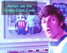 a man is standing in front of a screen that says always use the green cross code