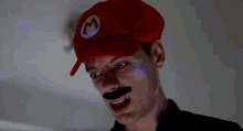 a man wearing a mario hat and fake mustache makes a funny face