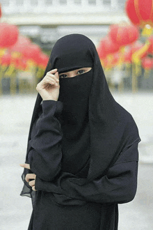 a woman wearing a black veil covering her face