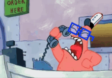 a cartoon character talking on a phone with a sign that says order here behind him