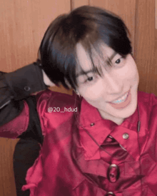 a young man in a red shirt is smiling and has the hashtag 20_hdud