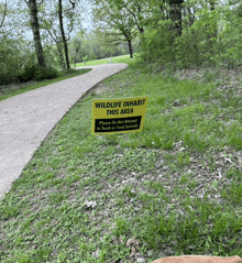 a wildlife inhabit this area sign on the side of a path