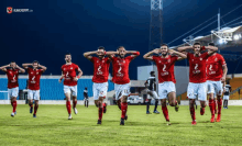 a group of soccer players wearing red and white uniforms with we on the front