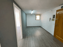 a hallway with a wooden door and a window