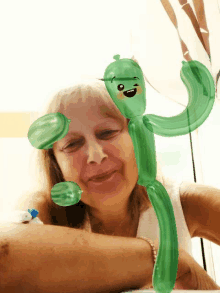 a woman with a cactus made out of balloons on her face