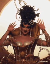 a picture of a drag queen with xtecrystali written on the bottom right