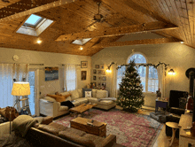 a living room decorated for christmas with a couch and a christmas tree