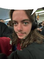 a man with long hair is wearing headphones and a microphone