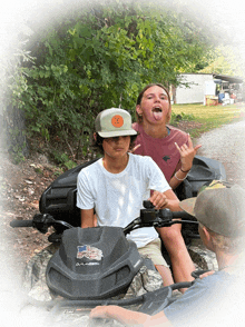 a girl sticking her tongue out while sitting on a polaris atv