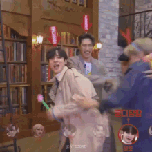 a group of men are playing with balloons in a room .