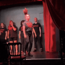 a group of people on a stage with one wearing a netflix t-shirt