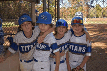 a group of young boys are posing for a picture and one of their shirts says titans