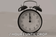 an alarm clock with the words 2 hours until drop written below it