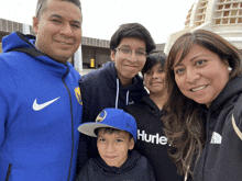 a group of people posing for a picture with one wearing a hurley shirt