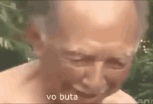 a close up of a man 's face with the words `` vo buta '' written in white letters .