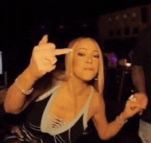 mariah carey is giving the middle finger to the camera .