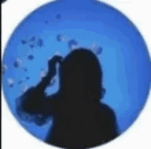 a silhouette of a woman in a blue circle with bubbles coming out of it .