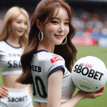 a woman holding a soccer ball with sbobet on it