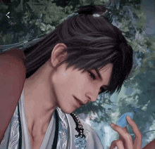 a man with long hair is holding a blue object