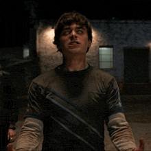 a young man with his eyes closed and his hands outstretched