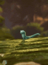 a cartoon lizard is standing on top of a mossy hill with its tongue out .