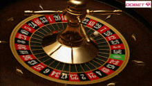 a close up of a roulette wheel with a dobet logo behind it