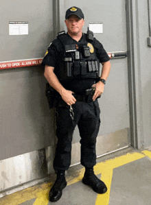 a police officer stands in front of a door that says alarm will sound