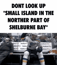 a hockey player is sitting on a bench with a caption that says " small island in the northern part of shelburne bay "