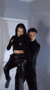 a man is carrying a woman in his arms in a doorway .