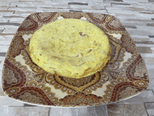 a tortilla on a plate with a paisley design