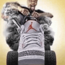 a man is riding a lawn mower made out of a pair of air jordan shoes .