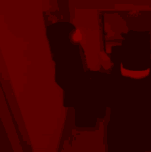 a person in a dark room with a red light on their head