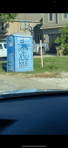 a blue portable toilet has graffiti on it that says " dsp if you kyle "