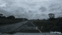 a video of a car driving down a road with the words viralhog on the bottom right