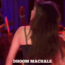 a woman in a black dress is dancing with the words dhoom machale above her