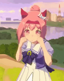 a girl with pink hair and red ears is standing in front of a river in a field .