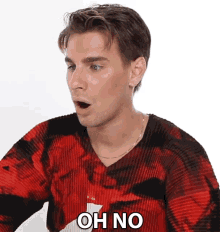 a man in a red and black sweater says " oh no "