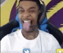 a man is sticking his tongue out while sitting in a chair .